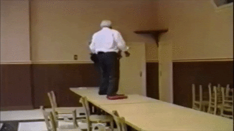 GIF of man falling off a table